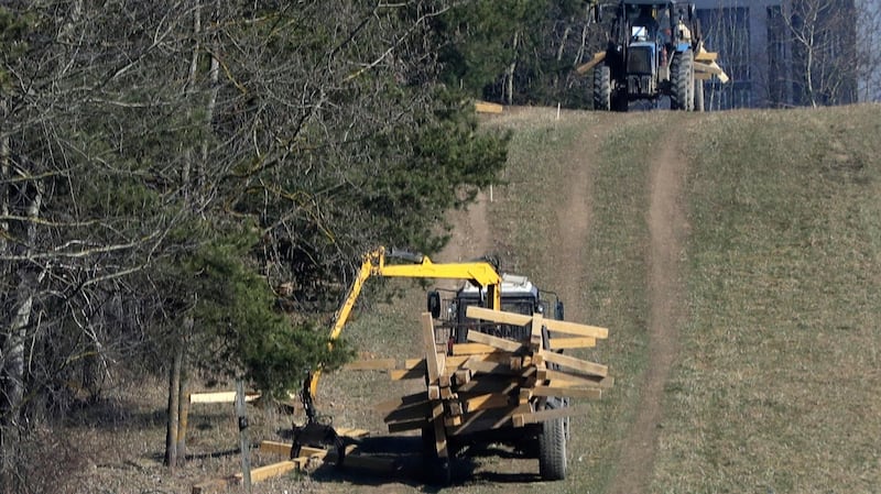 An automatic loader removes wooden crosses at the Kuropaty mass grave site of Soviet-era mass executions in the Belarus capital Minsk on April 4th, 2019. Photograph: Sergei Grits/AP