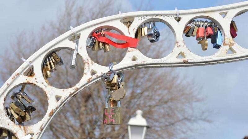 Dublin City Council has erected signs asking people not to attach locks to the bridge. Photograph: Alan Betson / The Irish Times