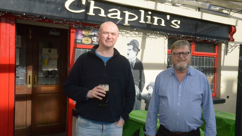 Customer Dan Gallagher and landlord John Collins at Chaplin’s bar in Bandon: In 2020, the lockdown was imposed just as Cheltenham was about to start. Photograph: Denis Boyle