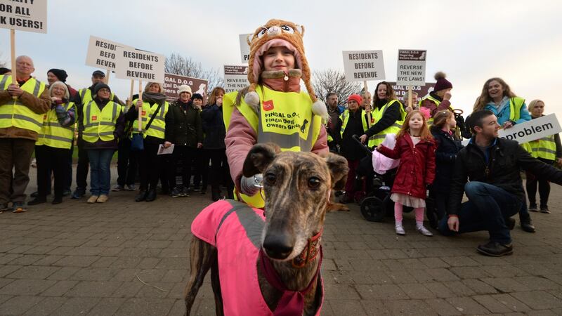 Ella Dooley with Lady, who joined the Fingal Dog Owners Group protest march. Photograph: Dara Mac Dónaill/The Irish Times