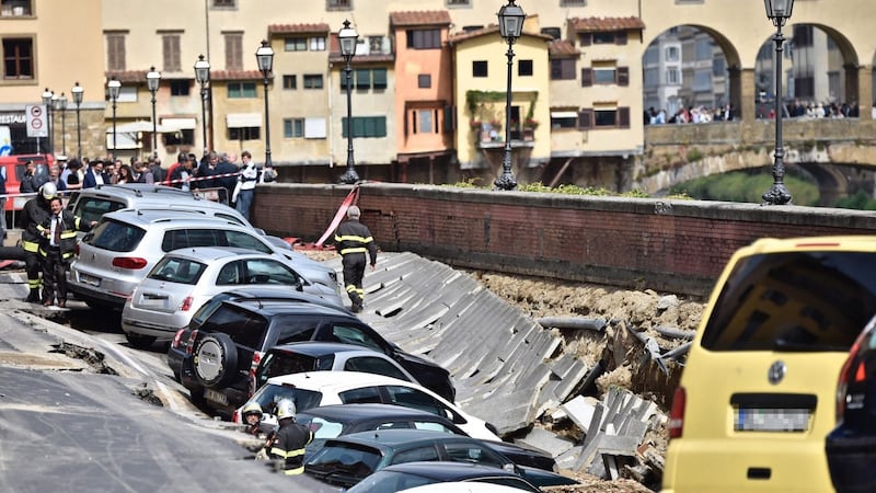 Vehicles stuck in a chasm near Ponte Vecchio, Florence. Photograph: Aurizio Degl’ Innocenti/EPA