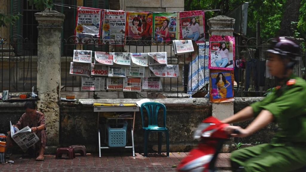 A newspaper vendor in Hanoi. While all Vietnamese newspapers and broadcasting stations are still owned by the Communist Party and subject to its control, formerly taboo issues such as low-level corruption and economic equality are discussed in some newspapers. Photograph: Hoang Dinh Nam/AFP/Getty Images)