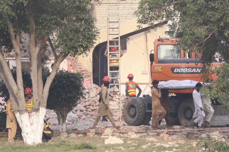 People move the body of a victim after an Indian missile strike in Muridke, Punjab province, Pakistan. Photograph: EPA