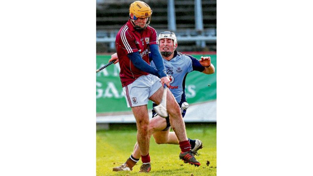 Galway's Johnny Coen clears his lines despite the attention of Dublin's Ross O'Carroll during Saturday's semi-final tie at Parnell Park. photograph: ryan byrne/inpho