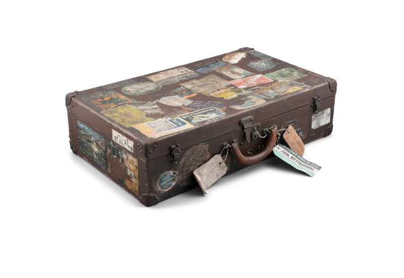 A different view of the early Louis Vuitton luggage case that's also shown at the top of this story. It comes covered with travel stickers and tags, with destinations ranging from the exotic to 'Inisfallen Way' (€500-€800).