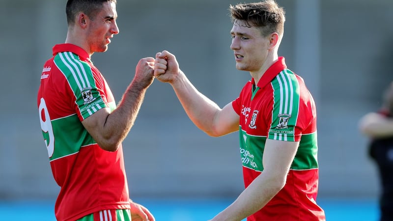James McCarthy and John Small celebrate Ballymun’s win over Kilmacud. Photograph: Laszlo Geczo/Inpho