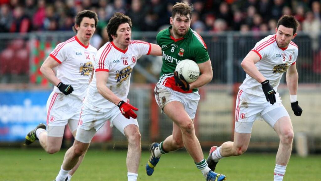 Aidan O’Shea of Mayo gets away from Seán Cavanagh, Mattie Donnelly and Conor Clarke of Tyrone. Photograph: Darren Kidd/Inpho/Presseye