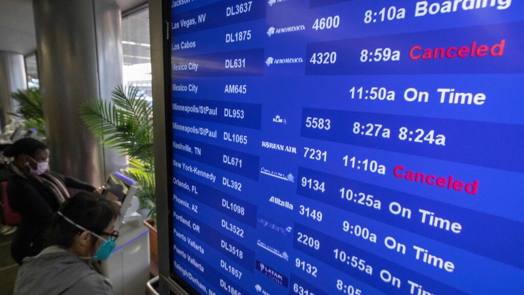 Travellers check for flight information at Los Angeles International Airport in Los Angeles, California. Photograph: DAVID MCNEW/AFP via Getty Images