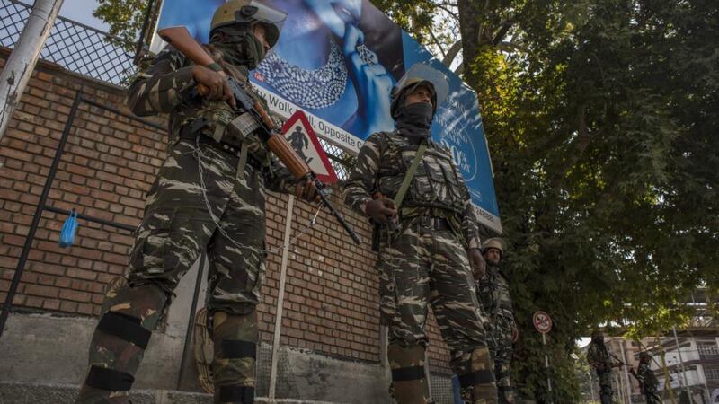Indian government forces guard the deserted city centre of Srinagar during curfew-like restrictions. Photograph: Yawar Nazir/Getty