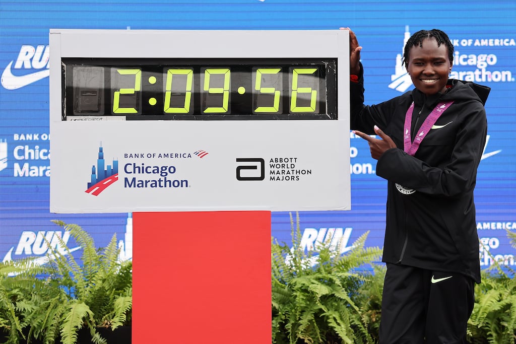 Ruth Chepngetich of Kenya poses with a clock after setting a new world record in Chicago. Photograph: Michael Reaves/Getty