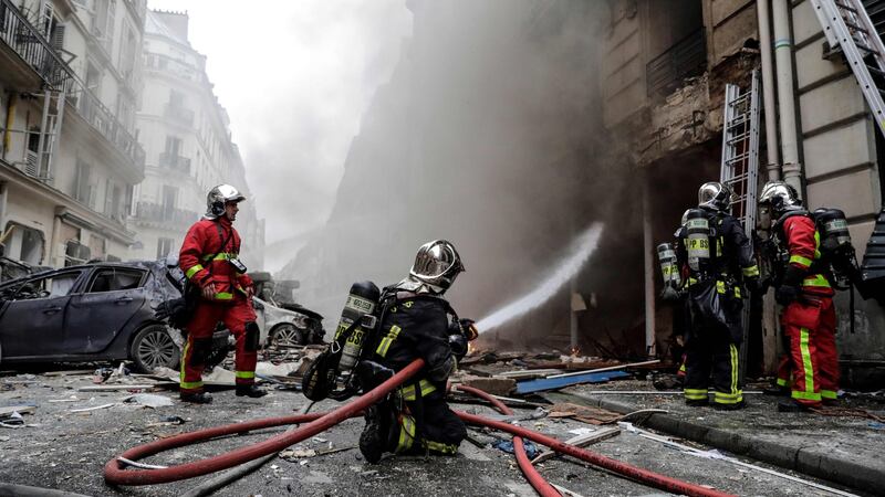 Firefighters extinguish a fire after the explosion of a bakery on the corner of the streets Saint-Cecile and Rue de Trevise. Photograph: Thomas Samson/AFP/Getty Images