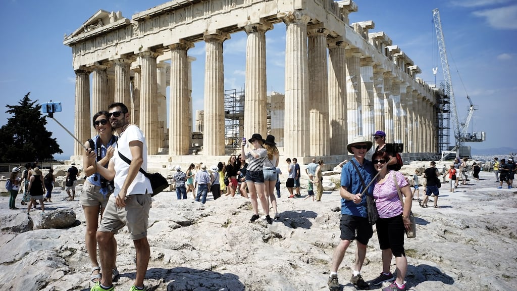 Tourists visit the ancient Acropolis hill: some 750,000 holidaymakers visited Greece between January and August. Photograph: Milos Bicanski/Getty Images