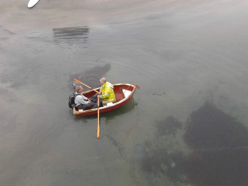 Michael Bob rowing Peter Gill out to his boat, The Nora Daly, from the pier on Clare Island to bring him to the mainland.