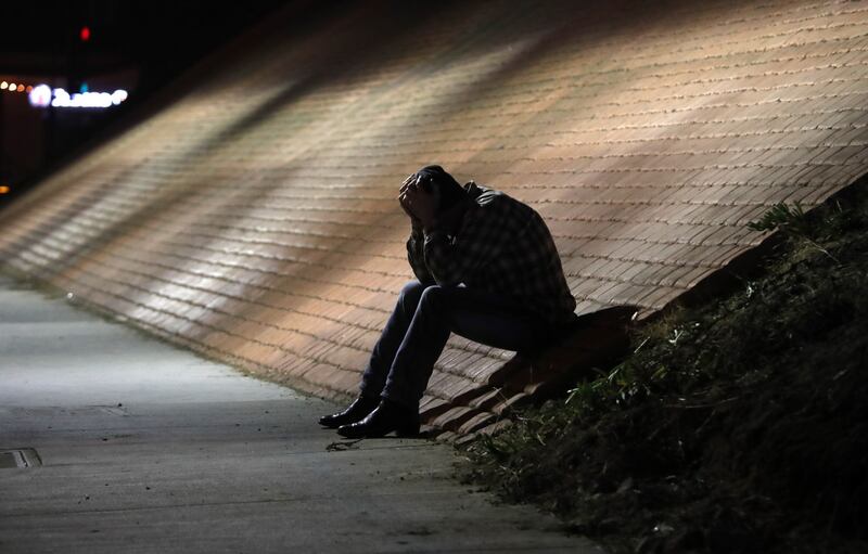 A man holds his head in his hands outside the Borderline Bar and Grill in Thousand Oaks, California on November 8th Photograph: Mike Nelson/EPA