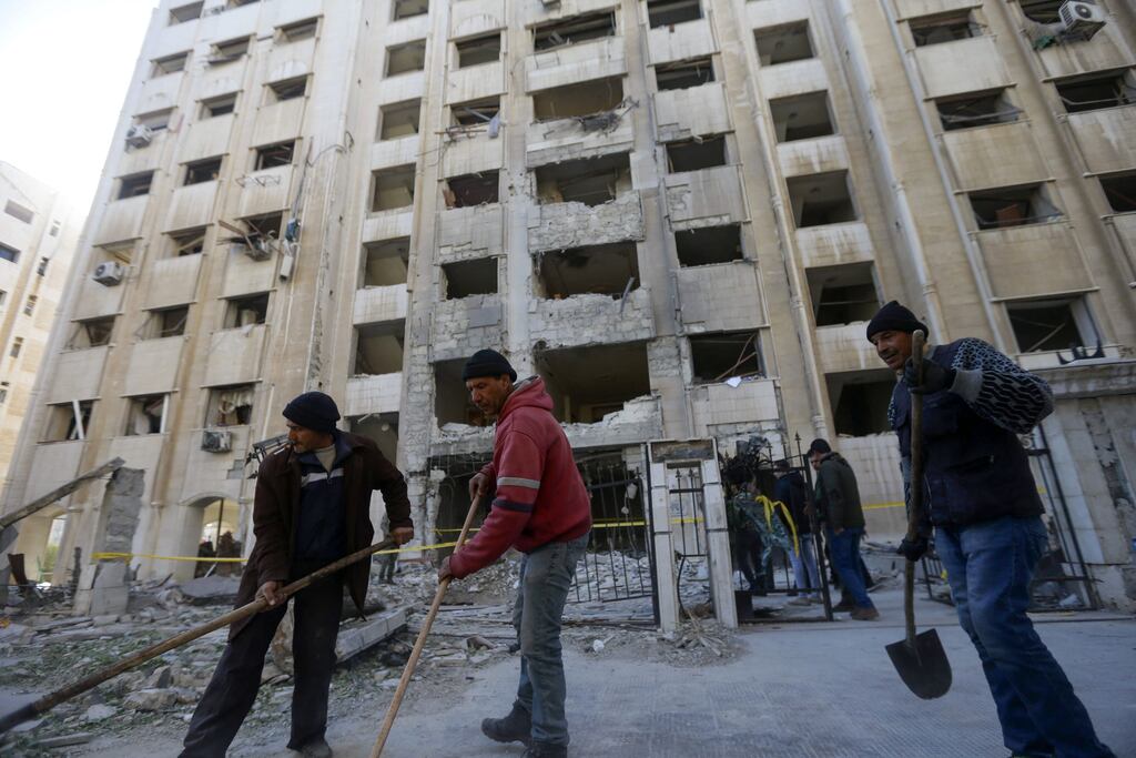People shovel debris at the scene of a reported Israeli missile strike in Damascus. Photograph: LOUAI BESHARA/AFP via Getty Images