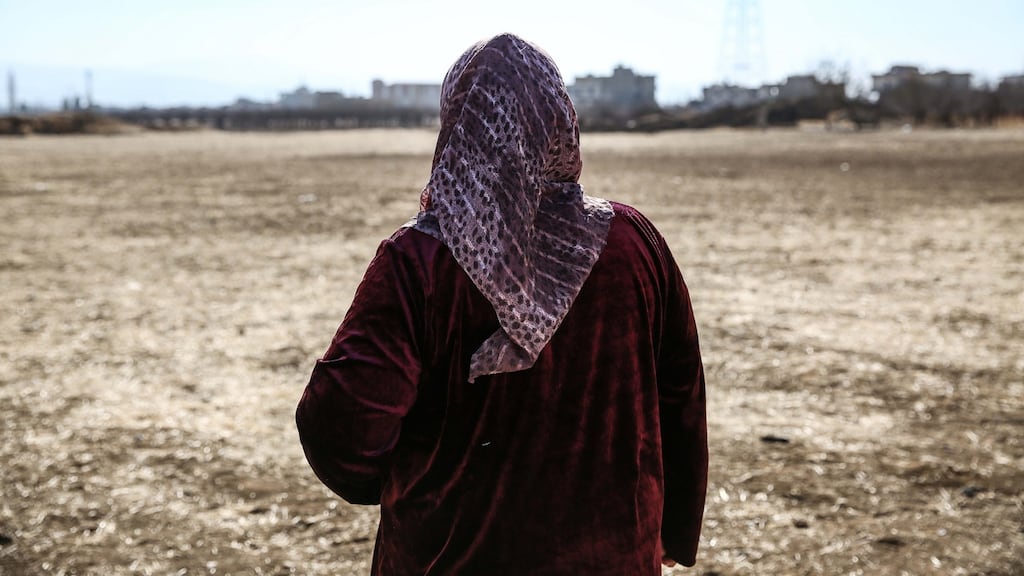 Syrian refugee Mona al-Shamali (52) looks out at the field where she now lives. Photograph: Sally Hayden