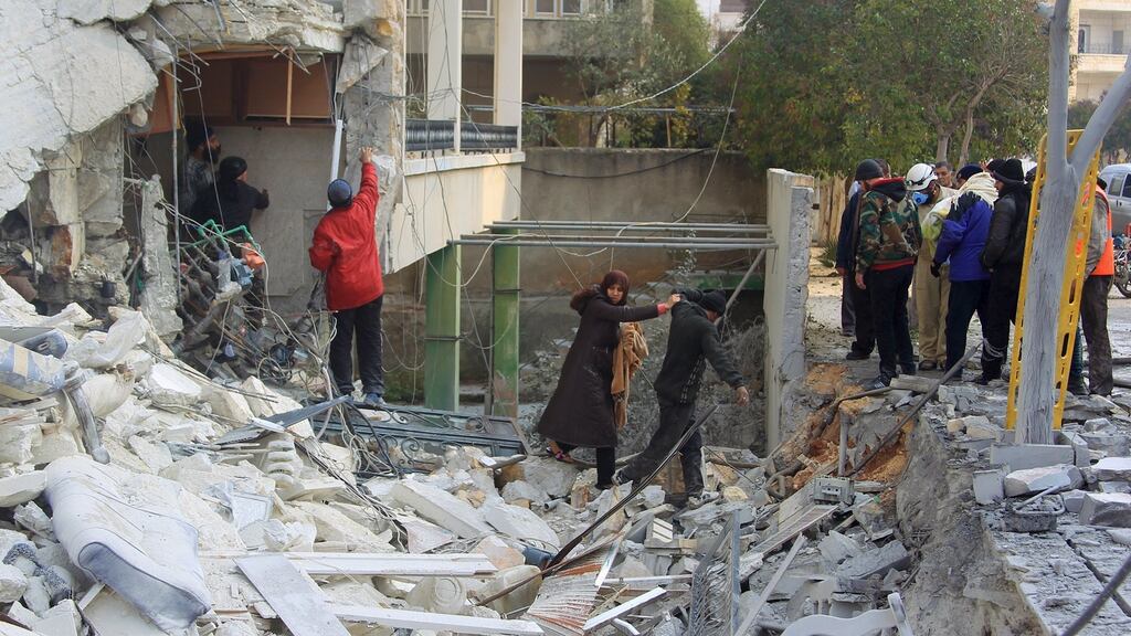 People make their way through the rubble of a damaged building after what activists said were airstrikes carried out by the Russian air force in Idlib, Syria on Sunday. Photograph: Ammar Abdullah/Reuters