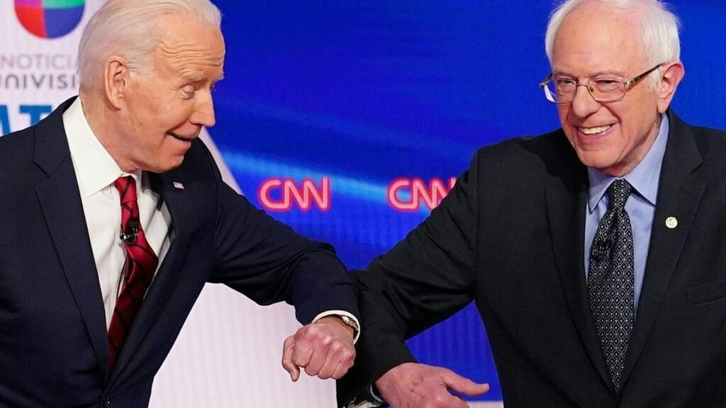 Democratic presidential hopefuls former US vice president Joe Biden and senator Bernie Sanders greet each other with an elbow bump before the start of their debate in Washington, DC on Sunday. Photograph: Mandel Ngan/AFP via Getty Images