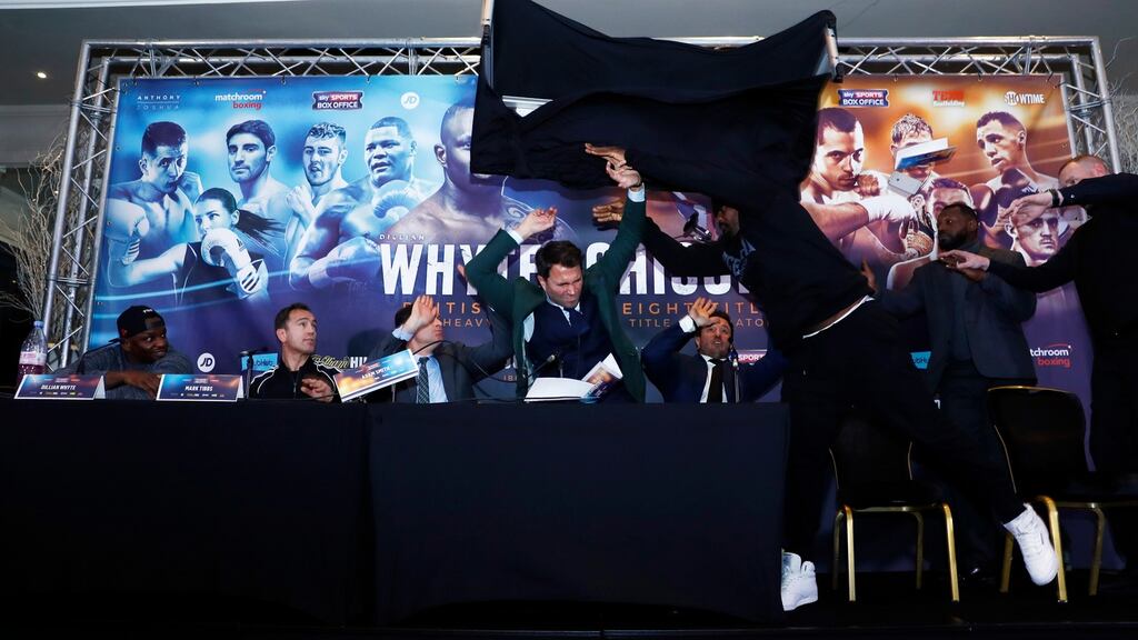 Dillian Whyte, trainer Mark Tibbs, Sky Sports’ Adam Smith, promoter Eddie Hearn and promoter Kalle Sauerland look on as Dereck Chisora throws a table during the press conference at the Radisson Hotel, Manchester. Photo: Jason Cairnduff/Reuters