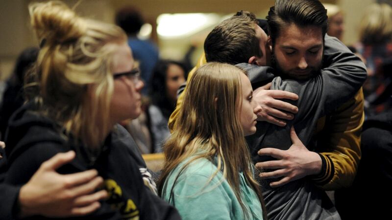 People hug at a vigil after six people were shot dead in Kalamazoo County, Michigan, on Sunday. Photograph: Reuters