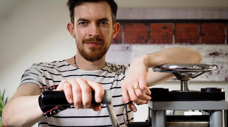 Nigel O’Reilly with his rolling mill, one of the oldest tools in his workshop, which flattens and forms gold