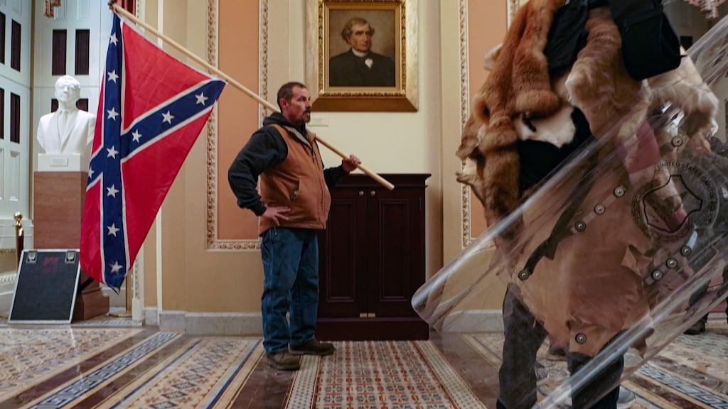 A supporter of Donald Trump carries a Confederate battle flag inside the Capitol building in Washington on Wednesday. Photograph: Erin Schaff/New York Times