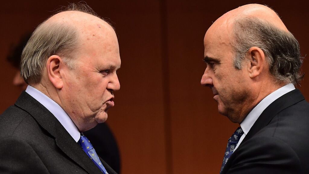 Finance Minister Michael Noonan (left) with Spanish finance minister Luis de Guindos Jurado:  of the 28 EU countries, the three that did worst on social justice are Ireland, Spain and Greece Photograph: Emmanuel Dunand/AFP/Getty