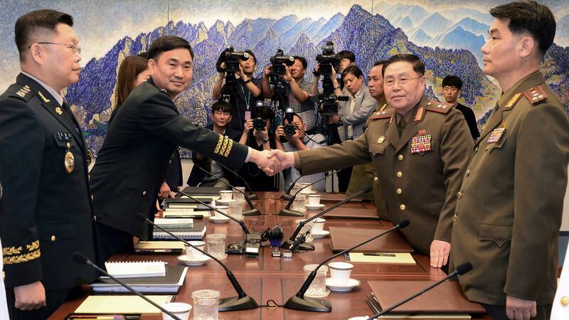 North Korean Lieut Gen An Ik San, second from right, shakes hands with his South Korean counterpart Maj Gen Kim Do-gyun during a meeting inside the Peace House at the border village of Panmunjom, South Korea, Tuesday. Photograph: Korea Pool/Yonhap via AP