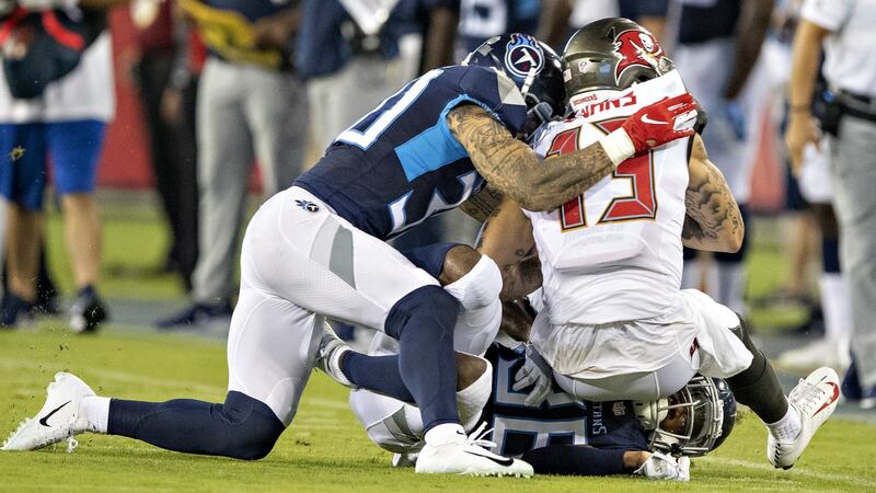 Kenny Vaccaro of the Tennessee Titans hits Mike Evans of the Tampa Bay Buccaneers and is called for helmet to helmet contact penalty. Photograph: Wesley Hitt/Getty Images
