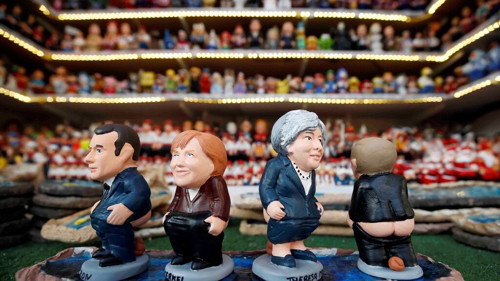 Stocking filler? Clay ‘caganer’ figures representing Emmanuel Macron, Angela Merkel, Theresa May and Vladimir Putin on sale in Barcelona, Spain. Photograph: Albert Gea / Reuters