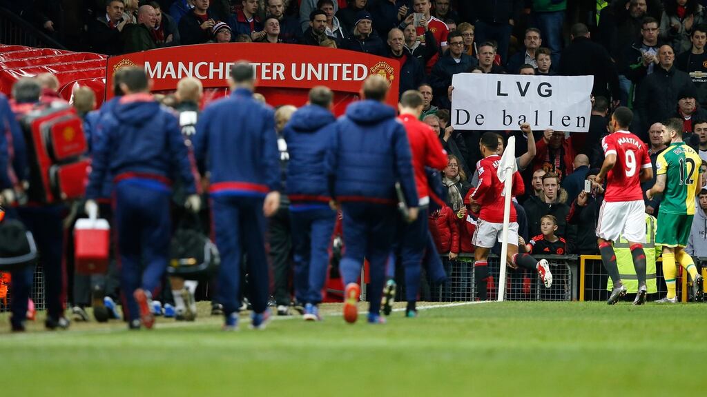 Manchester United fans hold up a banner towards manager Louis van Gaal as he walks off at half time which means, translated from the Dutch, ‘LVG goodbye’. Photo: Andrew Yates/Reuters