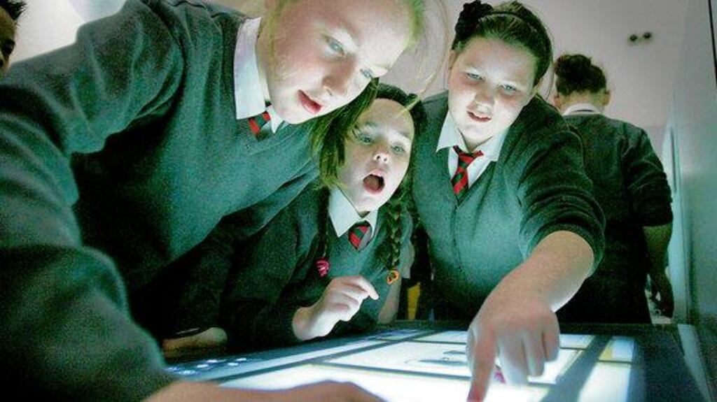 Rebecca O'Connor, Hollie Payne and Nadia Burke, from Scoil Caitríona, Baggot Street, using the interactive technology to view rare and valuable collections at the National Library yesterday.