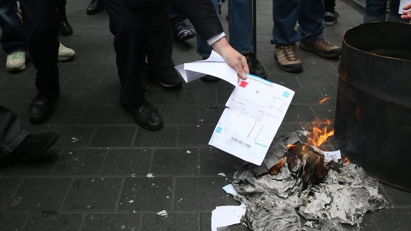 Protesters burn their water bills on O’Connell Street, Dublin. Photograph: Brian Lawless/PA