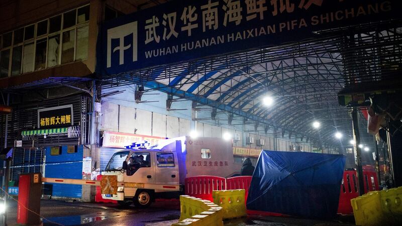Wuhan Hygiene Emergency Response workers leafe the Huanan seafood wholesale market in Wuhan, China, on January 11th, 2020. Photograph: Noel Celis/AFP/Getty