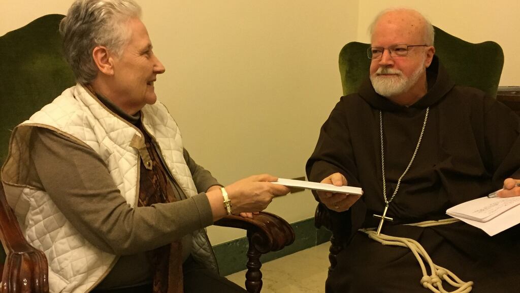 Marie Collins handing the letter detailing victims’ complaints of a sex abuse cover up in Chile to Cardinal Seán O’Malley on April 12th 2015.