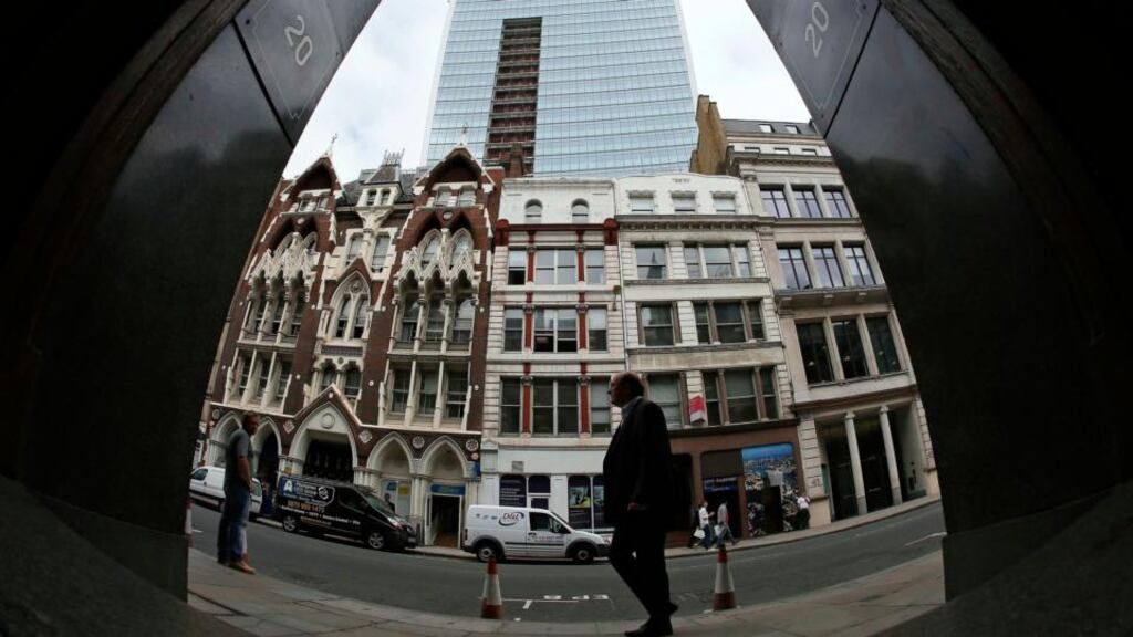 A man walks past suspended parking bays in front of the Walkie Talkie tower. Photograph: Stefan Wermuth/Reuters
