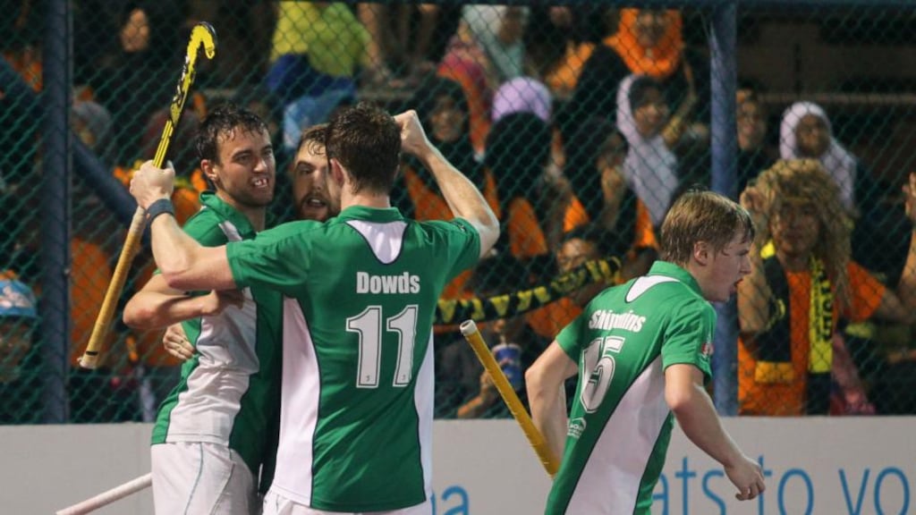 Irish players celebrate Chris Cargo’s goal against Malaysia yesterday.