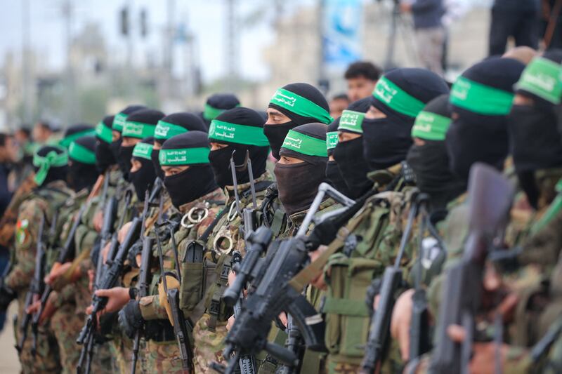Hamas fighters secured areas before handing over three Israeli hostages to a Red Cross team in Deir el-Balah, central Gaza. Photograph: Eyad Baba/AFP
