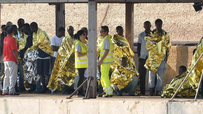 Immigrants disembark as they arrive in the island port this morning. Photograph: Tullio M. Puglia/Getty Images