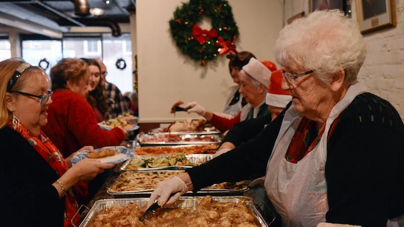 Board member Bridie Mitchell serves Christmas lunch at the New York Irish Center. Photograph: Lauren Crothers