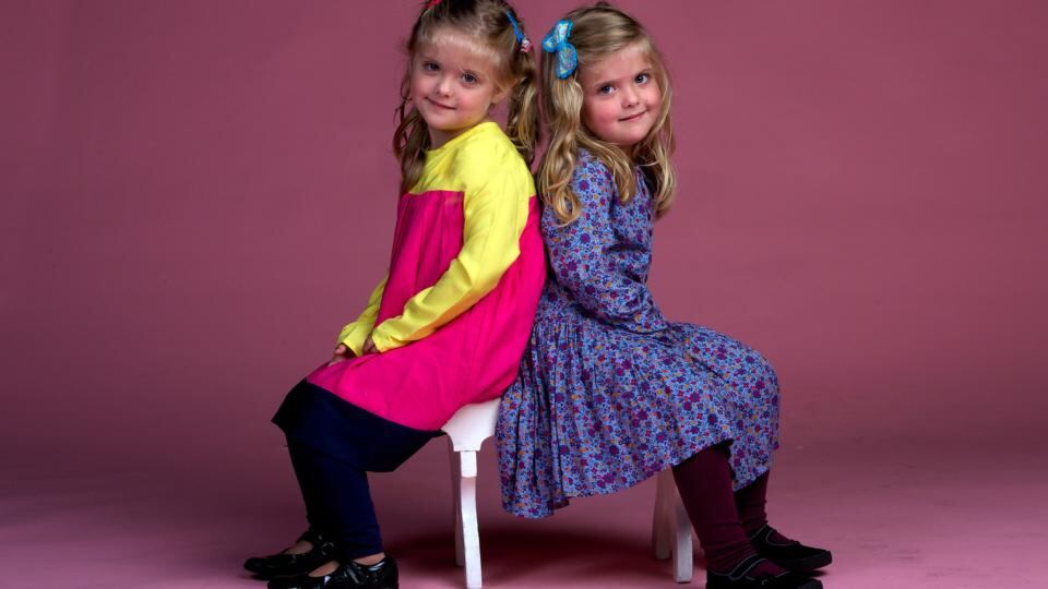 Priya (right) wears a purple print dress with tights; Joyas wears a yellow cerise and navy dress with leggings; both €24, Marks & Spencer