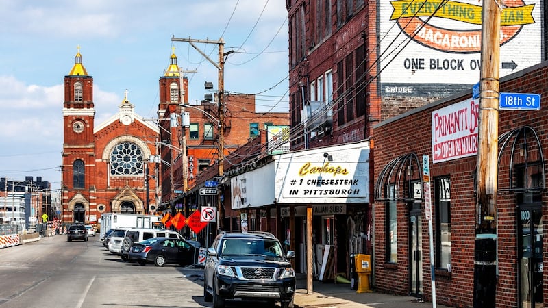 Street in Strip District, famous Primanti Bros. Restaurant & Bar in the right. Pittsburgh, Pennsylvania, USA