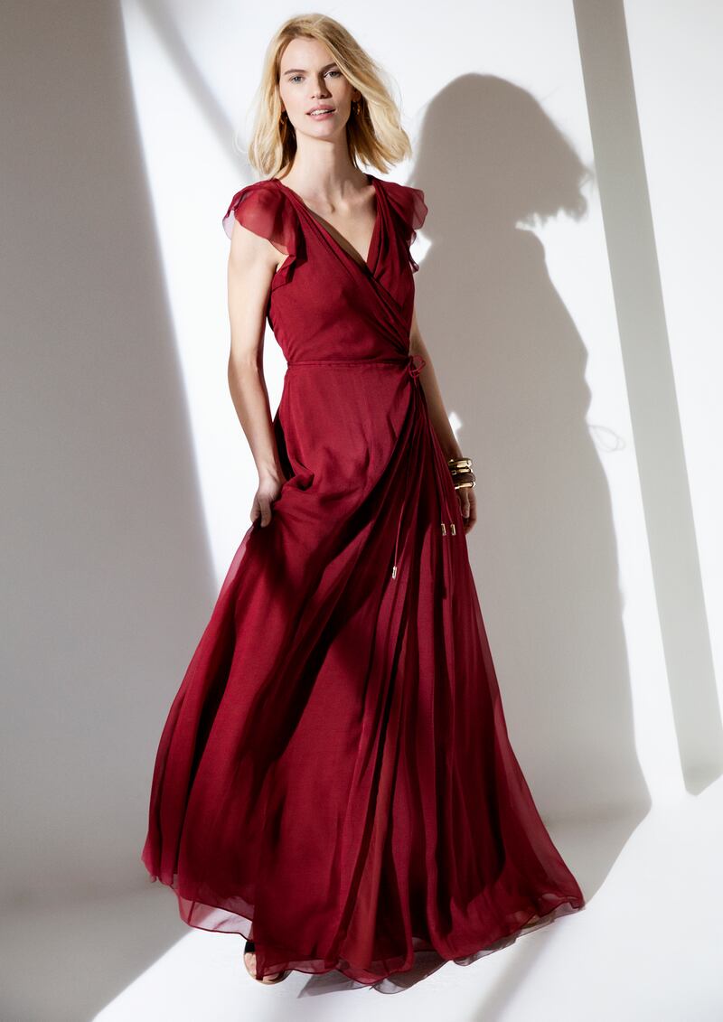 Burgundy wrap dress (was €610, now €366) at DVF; black flat sandals (were €98, now €39) at The White Company; gold hoop earrings (were €160, now €110) at Links of London; small wooden bangle (was €790, now €395); and large wooden bangle (was €890, now €445) both Roberto Cavalli
