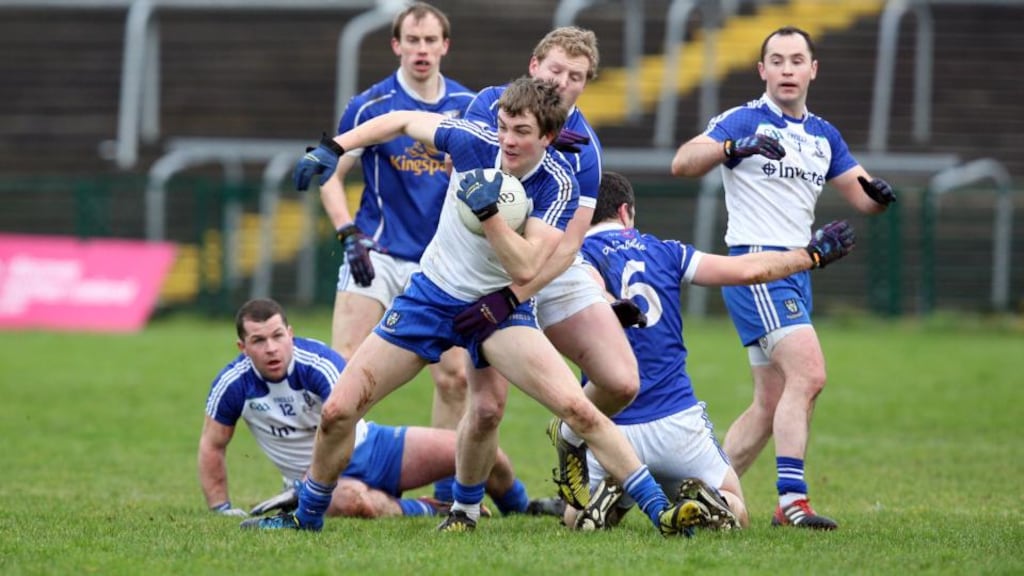 Jack McCarron of Monaghan is tackled by Cavan’s James McEnroe during the McKenna Cup semi-final at Brewster Park. Photograph: Andrew Paton/Inpho.