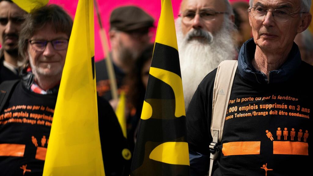 Unions representative members gather in front of Paris’ courthouse on Monday, the first day of the trial of  former members of France Telecom’s management for ‘moral harassment’. Photograph: Lionel Bonaventure/AFP/Getty Images
