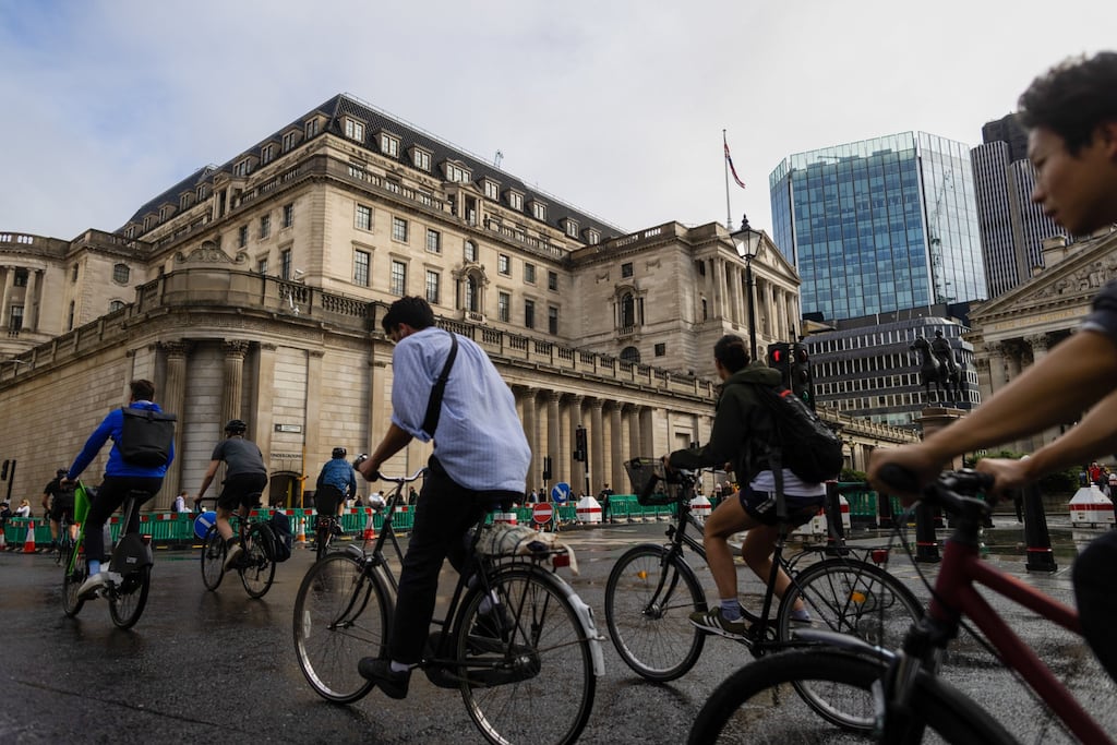 Cyclists pass the Bank of England (BOE) in the City of London, UK. Photograph: Chris Ratcliffe/Bloomberg