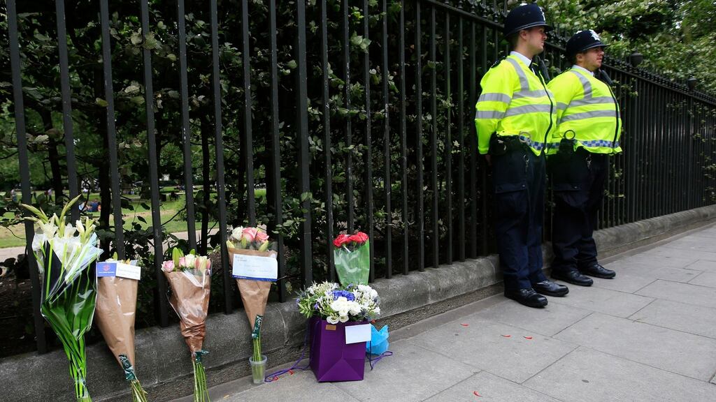 Floral tributes rest against railings near the scene of a stabbing in Russell Square, London, in which a woman was killed and five people injured.  Photograph: Jonathan Brady/PA Wire