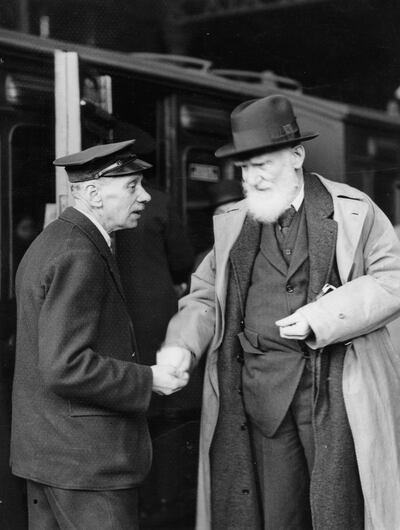 George Bernard Shaw with a porter at the Liverpool Street Station on his departure to New Zealand on February 8th, 1934. Photograph. Photograph: Imagno
