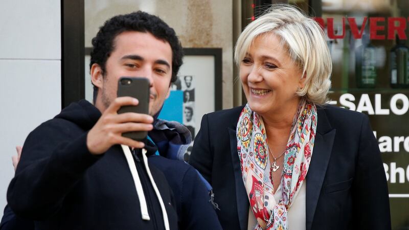Marine Le Pen poses for a selfie as she leaves the hair dresser in front of her campaign headquarters in Paris on Monday. Photograph: Reuters