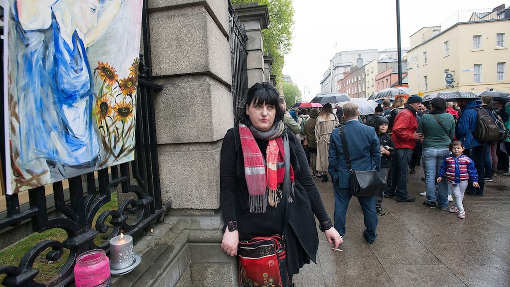 A vigil outside the Dáil on Friday for Dara Quigley. Pictured is her friend Dolly Murphy with her painted impression of Dara. Photograph: Dave Meehan